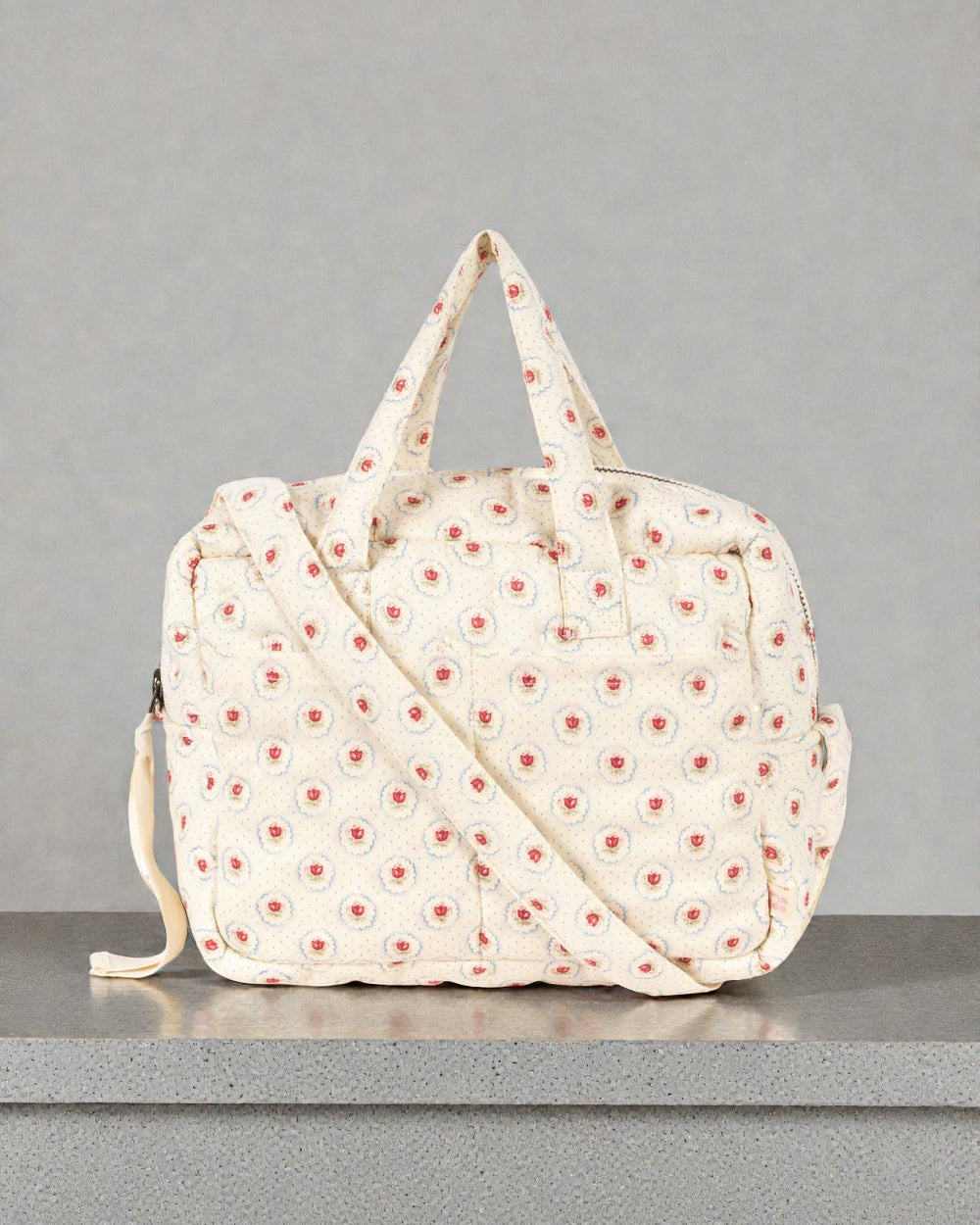 Konges Sløjd Mirage doll diaper bag with red tulip print and dual carry options