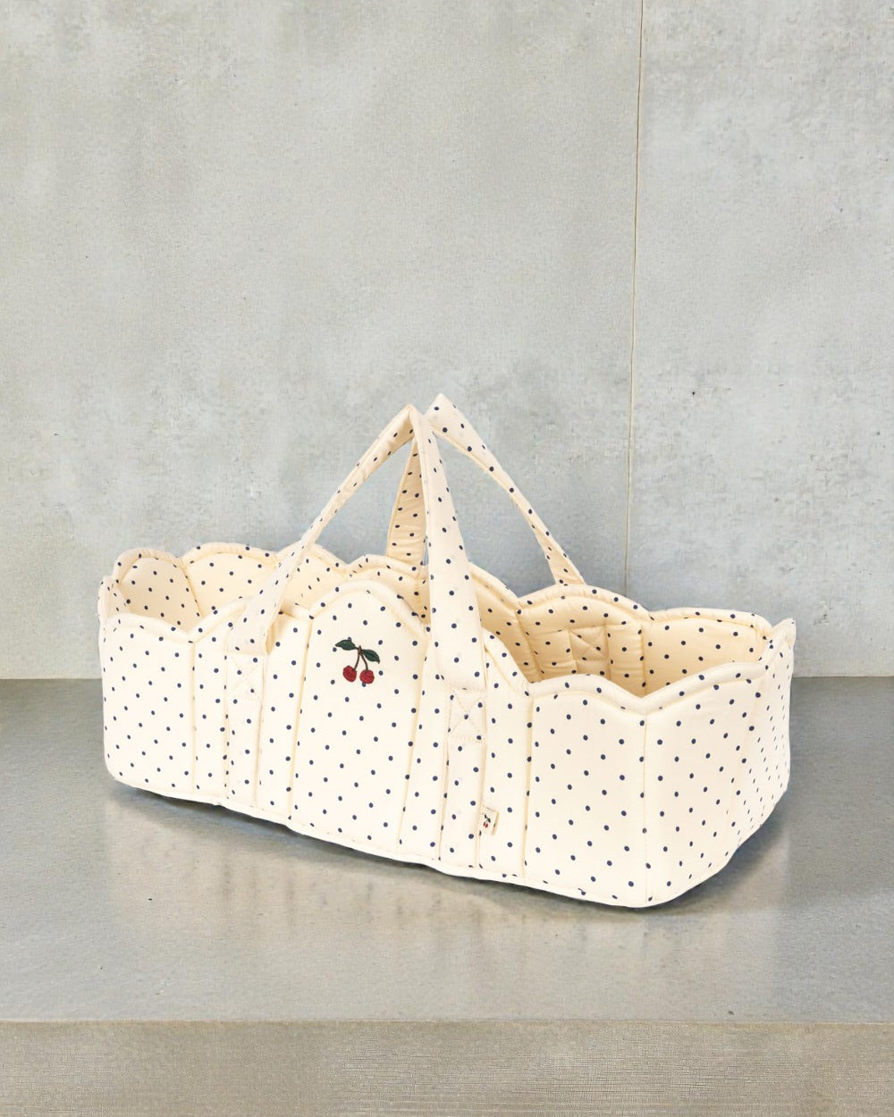 Konges Sløjd Estate Dot doll bassinet with navy polka dots and cherry embroidery detail