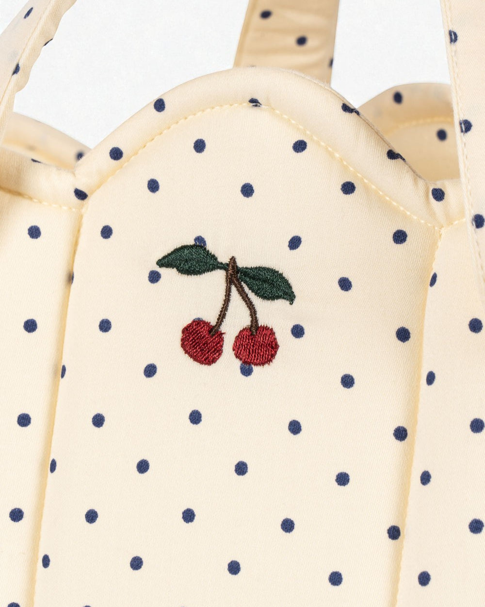 OEKO-TEX cotton bassinet showing cream fabric with blue polka dot pattern