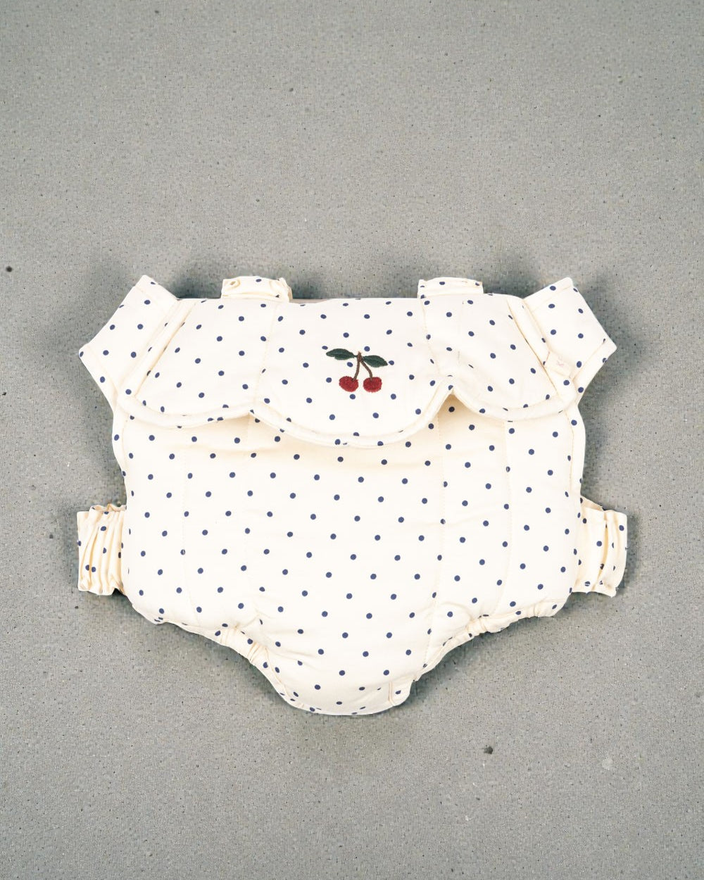 Konges Sløjd Estate Dot doll carrier with navy polka dots and cherry embroidery