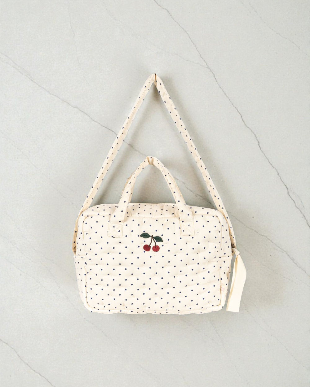 Konges Sløjd Estate Dot doll diaper bag with navy polka dots and cherry embroidery