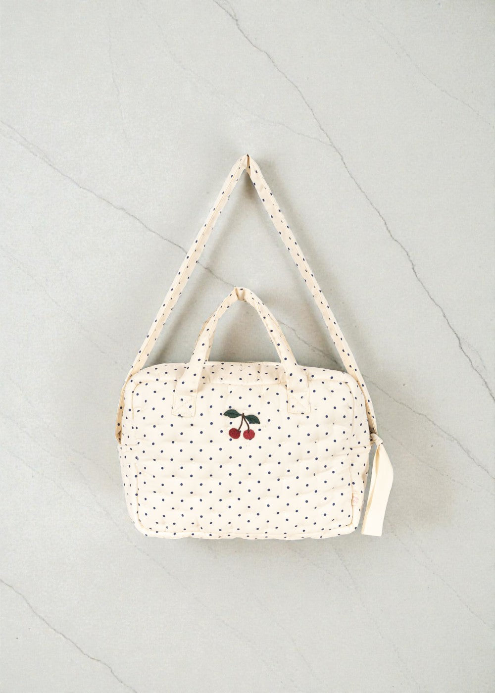 Konges Sløjd Estate Dot doll diaper bag with navy polka dots and cherry embroidery