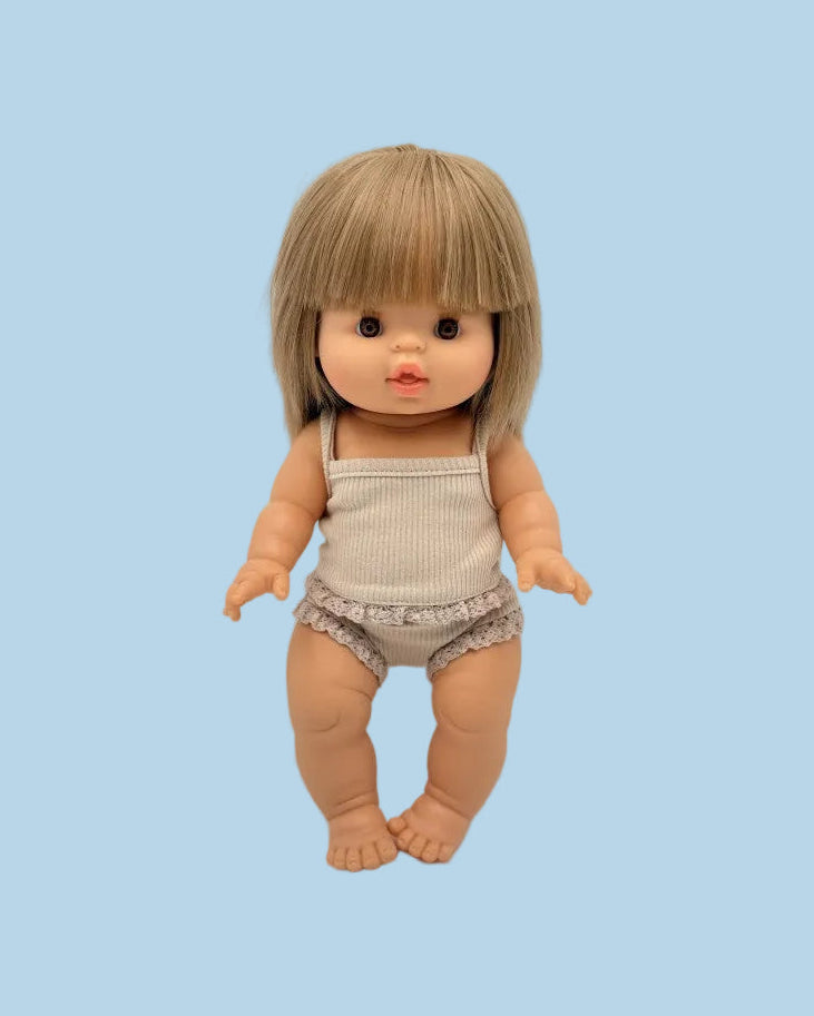 Doll with blonde hair and a beige outfit