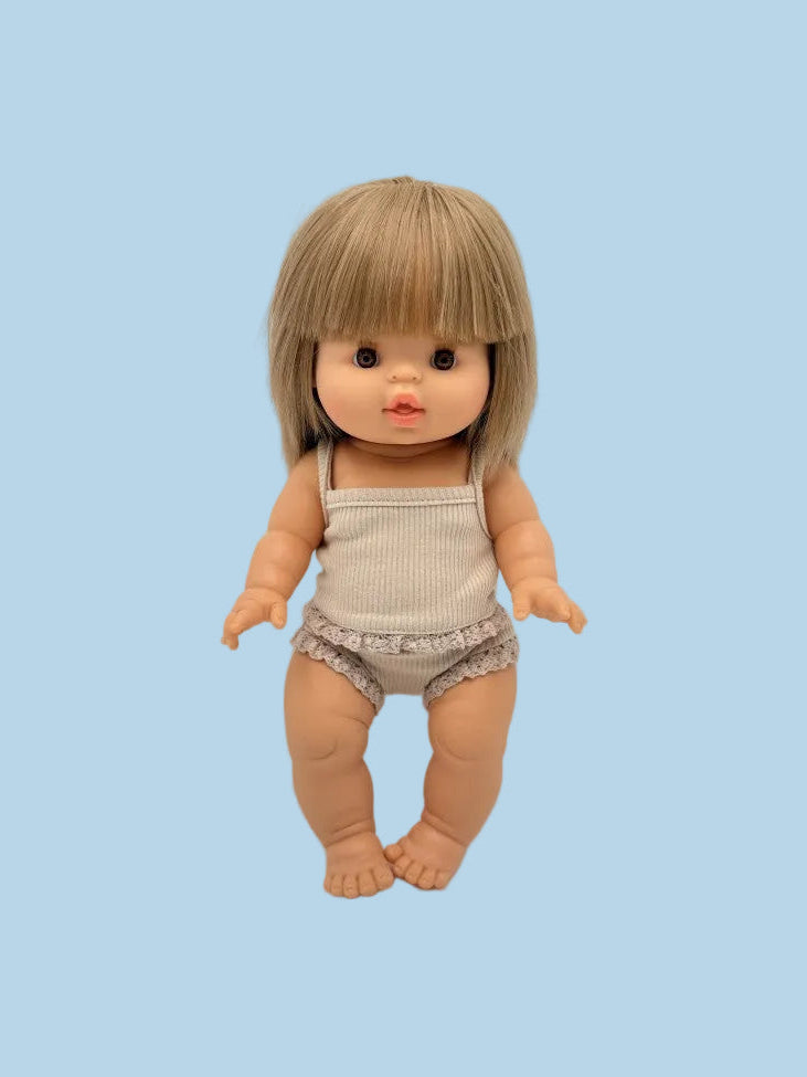 Doll with blonde hair and a beige outfit