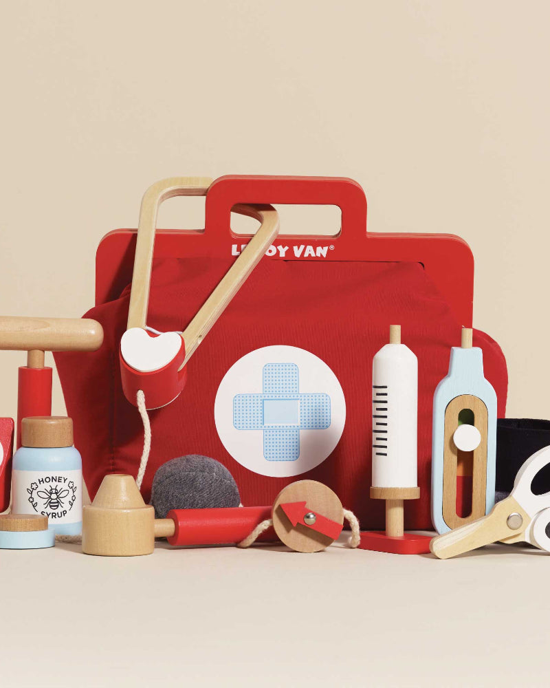 Le Toy Van vintage doctor kit with nine wooden medical tools in red bag