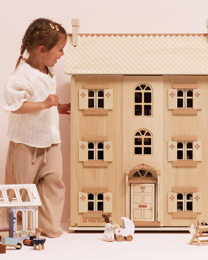 Large four-story Le Toy Van dollhouse in natural wood finish