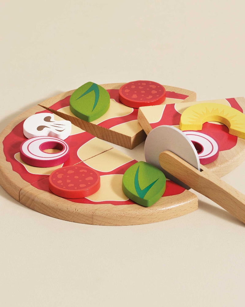 British made sliceable wooden pizza with toppings in pizza box packaging