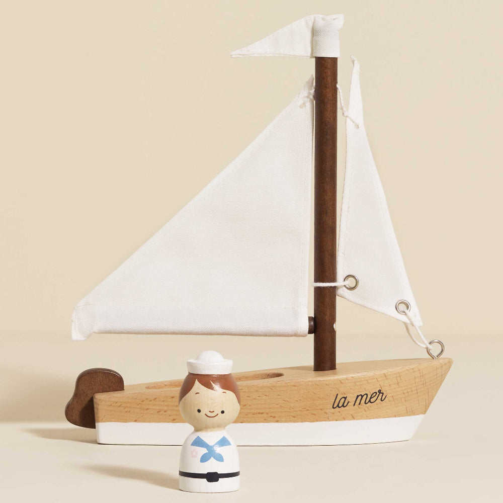 Natural beechwood toy boat with walnut accents and fabric flag