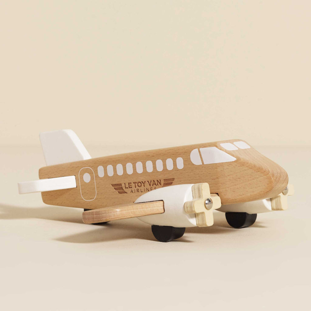Natural wood toy plane with engraved details and white accents
