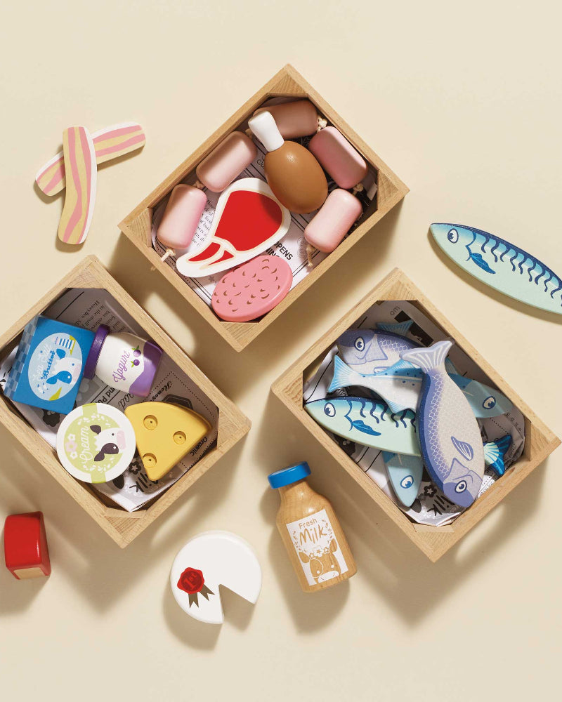 Set of wooden toys shaped like food items on a beige background