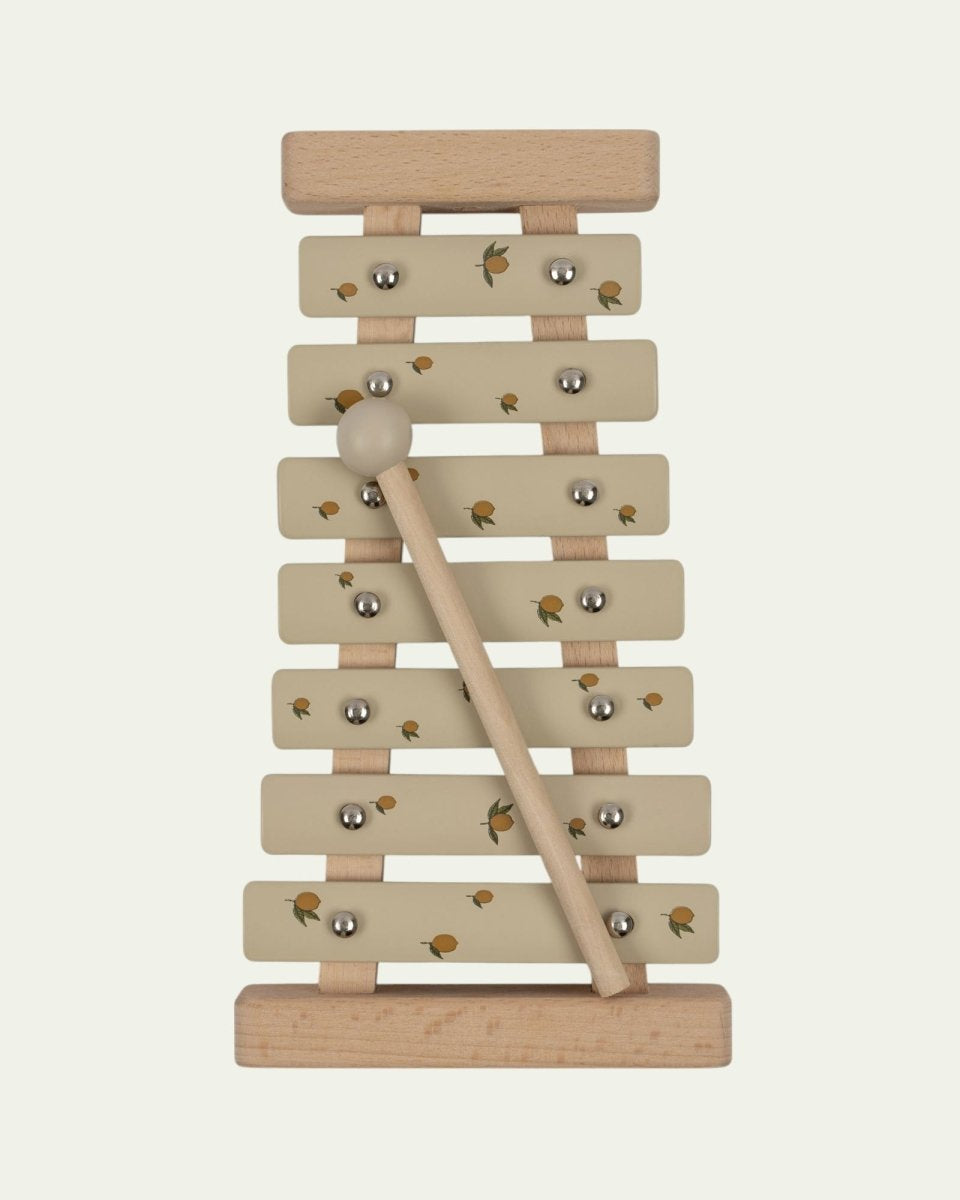 Wooden lemon print xylophone with sage green bars and natural wood mallet on white background