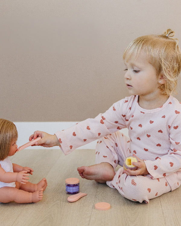 Young child wearing Korean-crafted ribbed set in Dreamy Mauve Hearts pattern