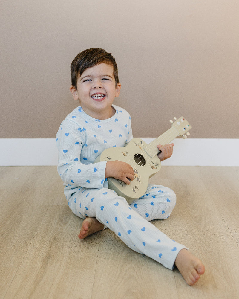 Toddler in blush pink heart print comfort wear showing stretchy movement and fit