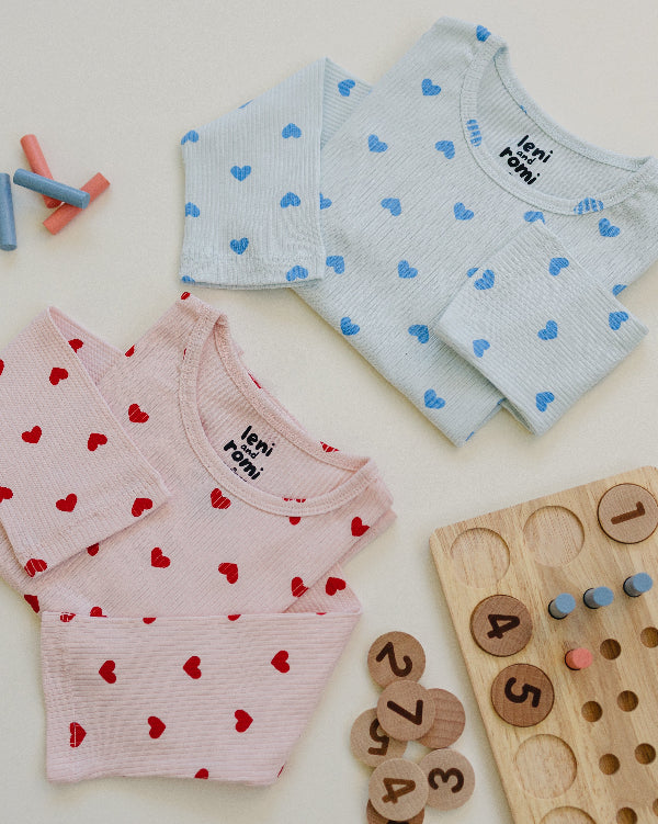 Close-up of Leni & Romi tagless ribbed texture with scattered red hearts pattern