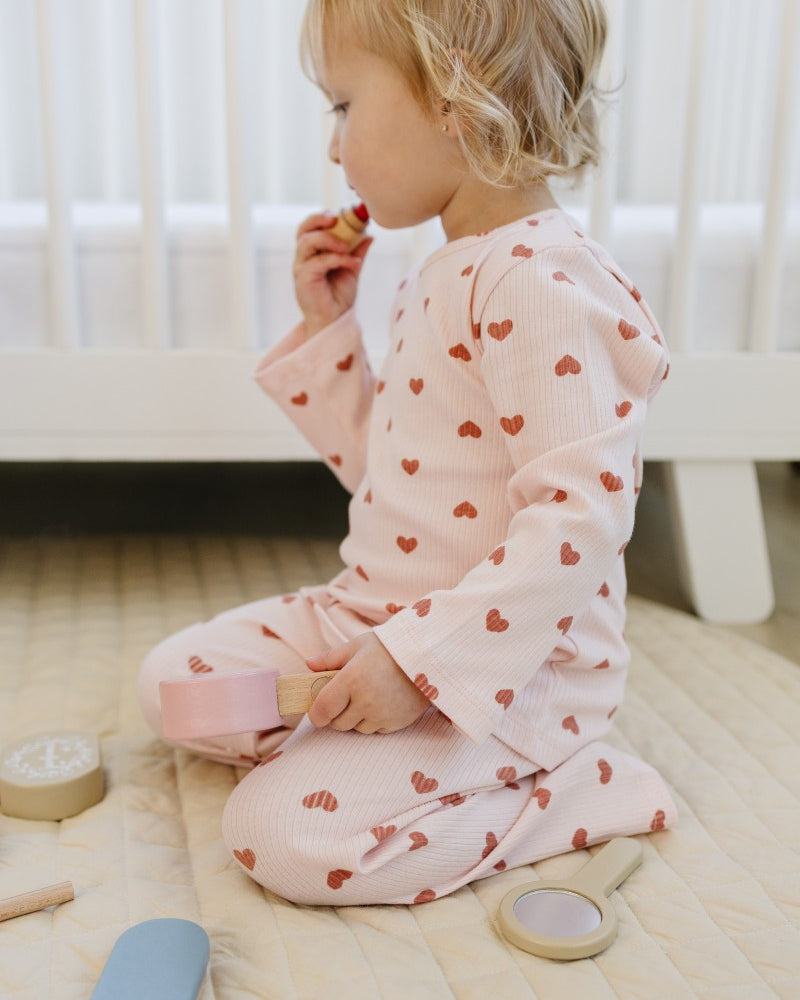 Kid playing in Dreamy Mauve Hearts premium comfort wear with blush pink base