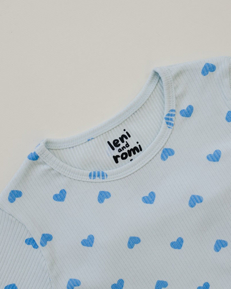Close-up of Leni & Romi tagless ribbed texture with sky blue hearts scattered pattern