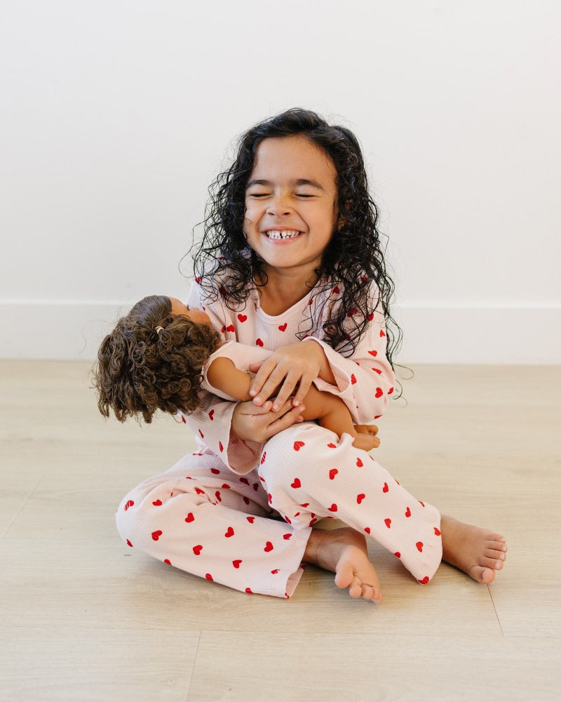 Toddler in blush pink heart print comfort wear showing stretchy movement and fit