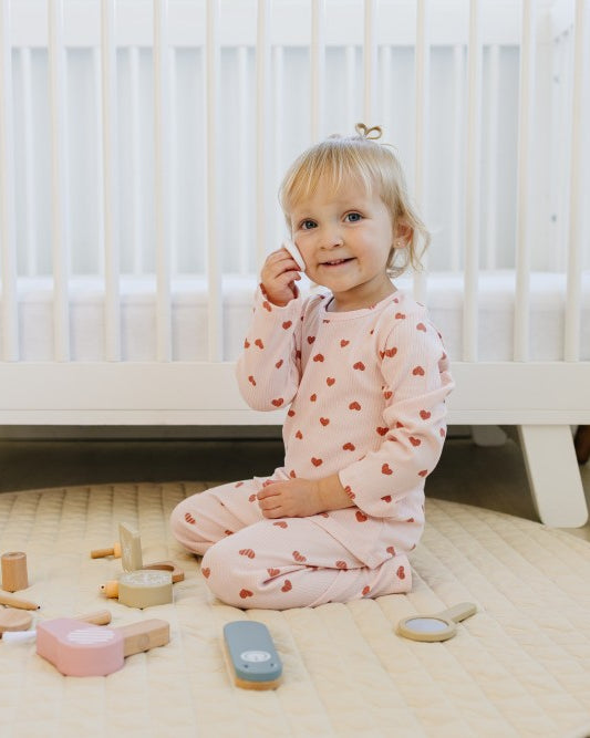 Child wearing Dreamy Mauve Hearts ribbed cotton play set for comfortable indoor activities