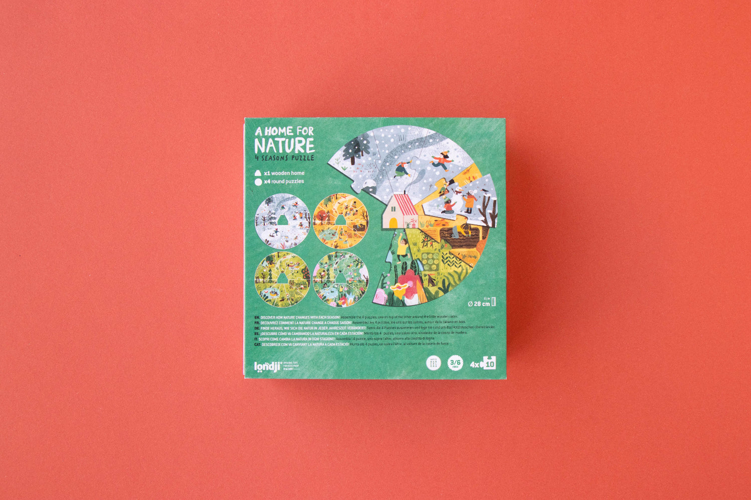 Green packaging box with nature-themed illustrations on a red background