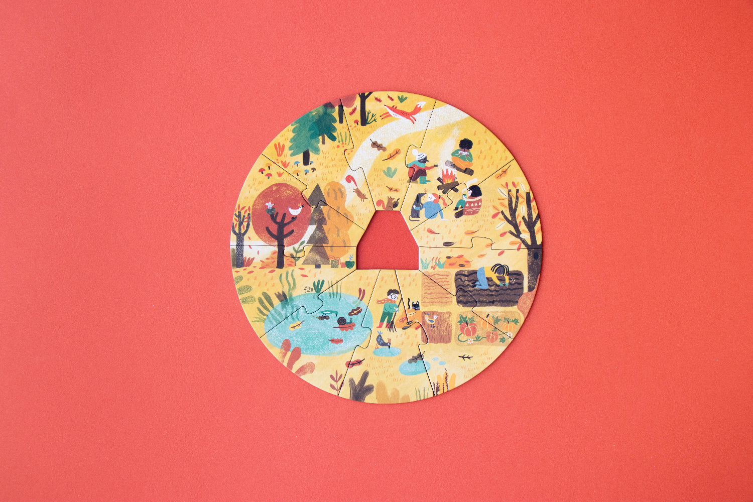 Circular paper cutout with illustrations of children playing on a red background