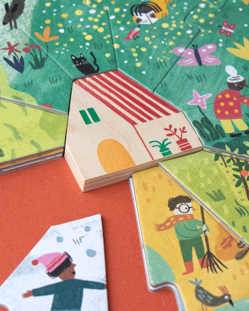 Children's puzzle with colorful illustrations of a house and people on a red surface