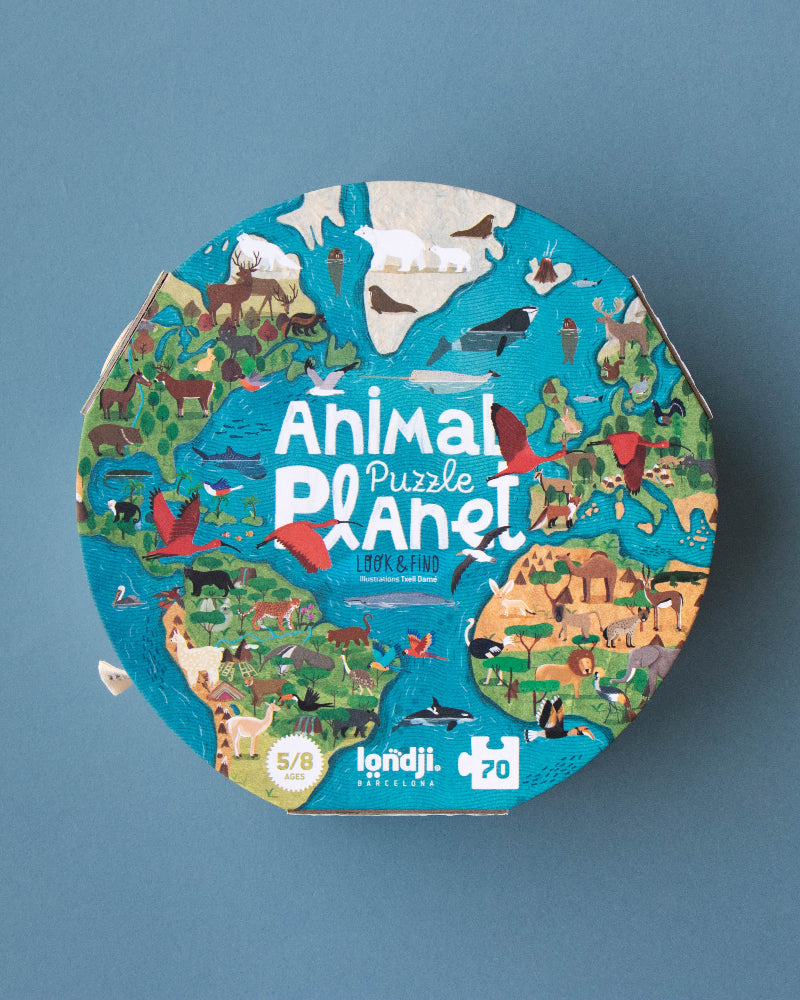 Round puzzle box with 'Animal Puzzle Planet' design on a blue background