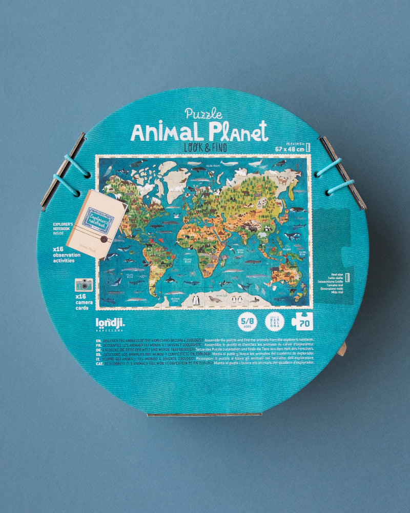 Round puzzle box with world map design on a blue background