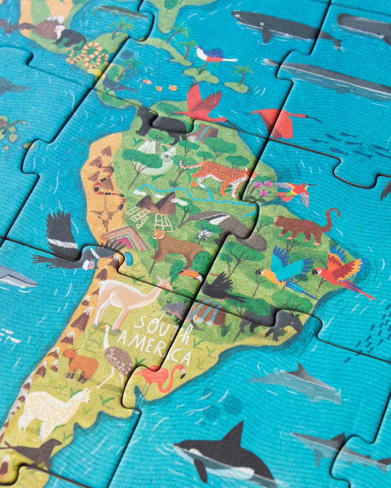 Children's puzzle with a map of the world and animals on a blue background