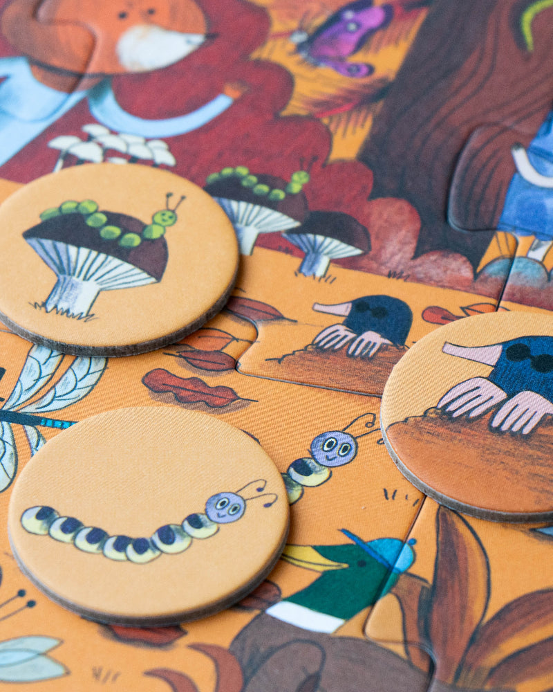 Wooden buttons with animal designs on a colorful fabric background