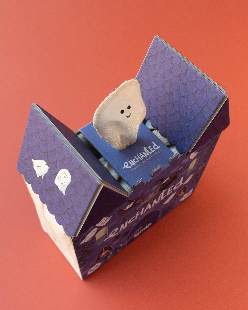 Small plush toy inside a purple box on an orange background