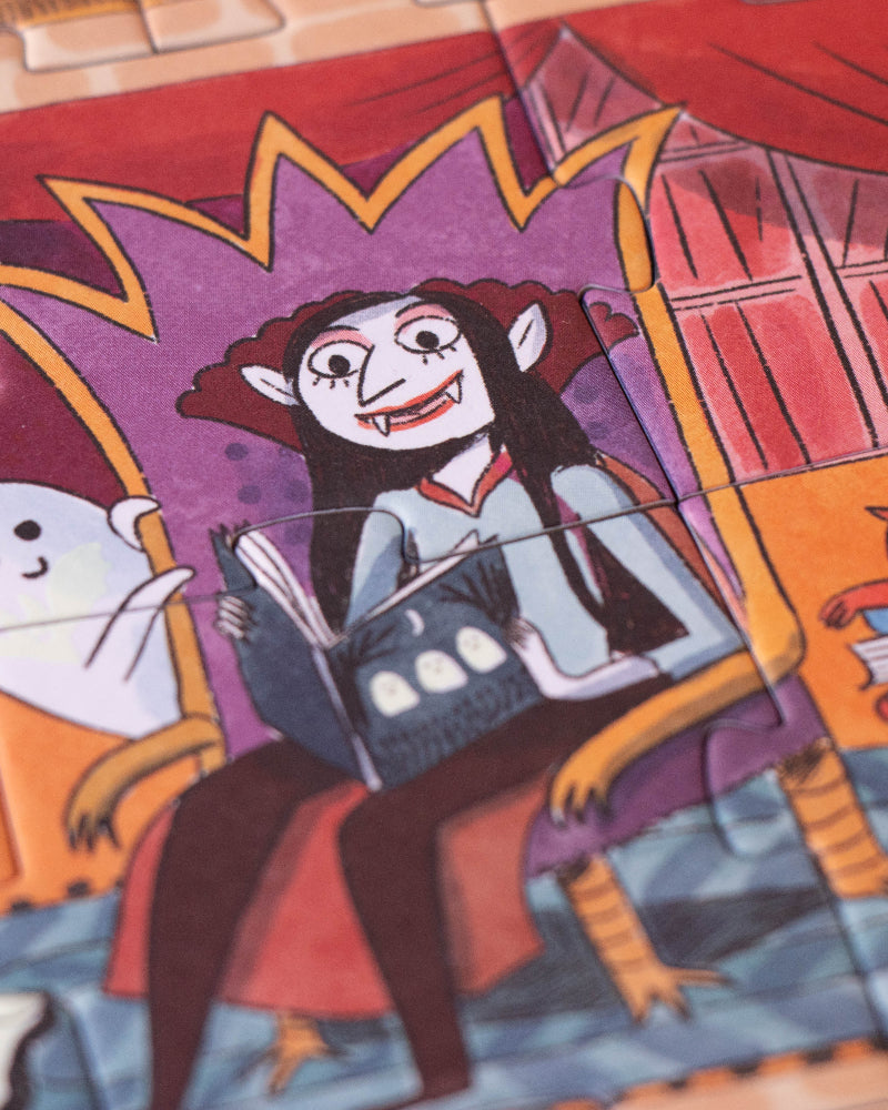 Halloween-themed puzzle with a witch and ghosts on a wooden surface