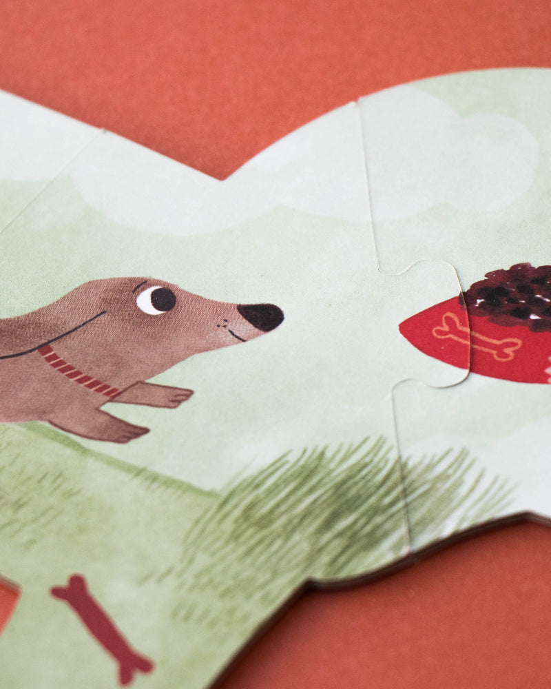 Children's book illustration with a dog and a hand holding a bone on a red background