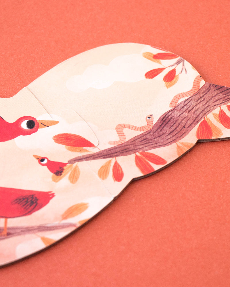 Puzzle with bird design on a coral background