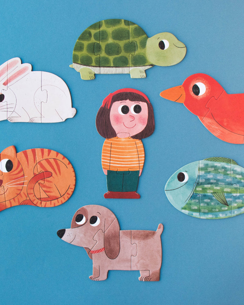 Set of colorful animal and character puzzles on a blue background