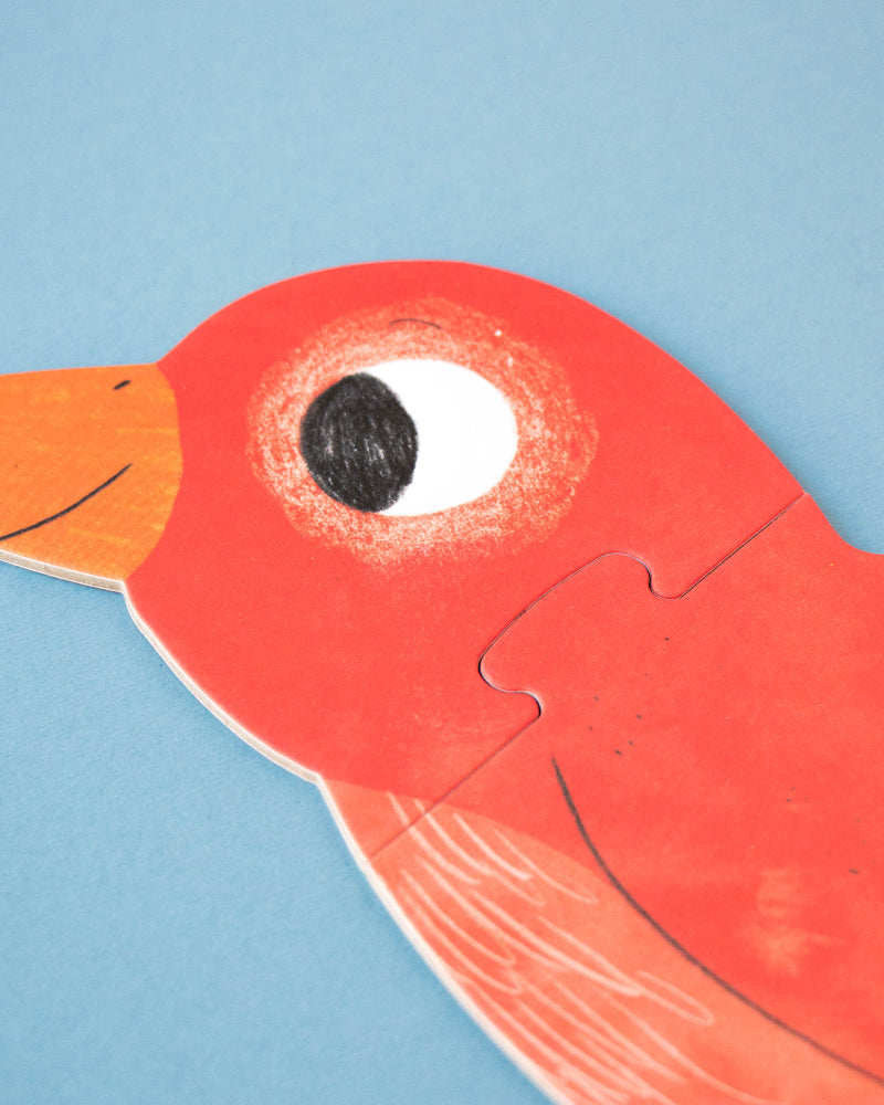 Red bird-shaped puzzle piece on a blue background
