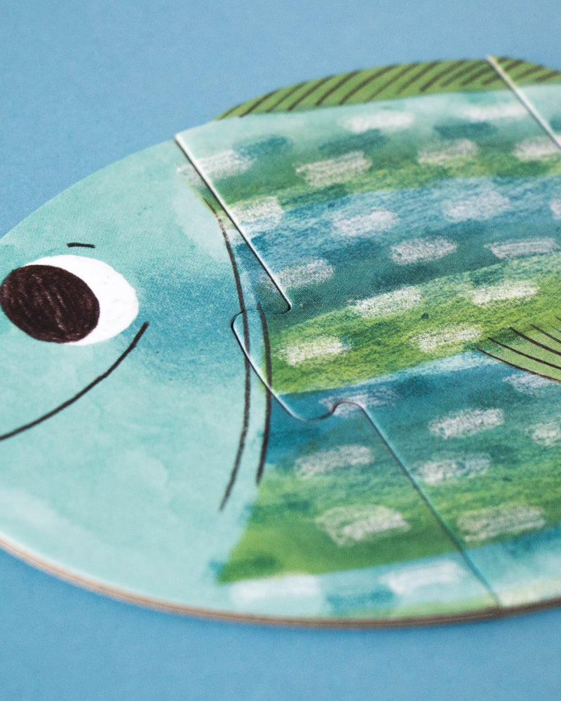 Fish-shaped puzzle on a blue background