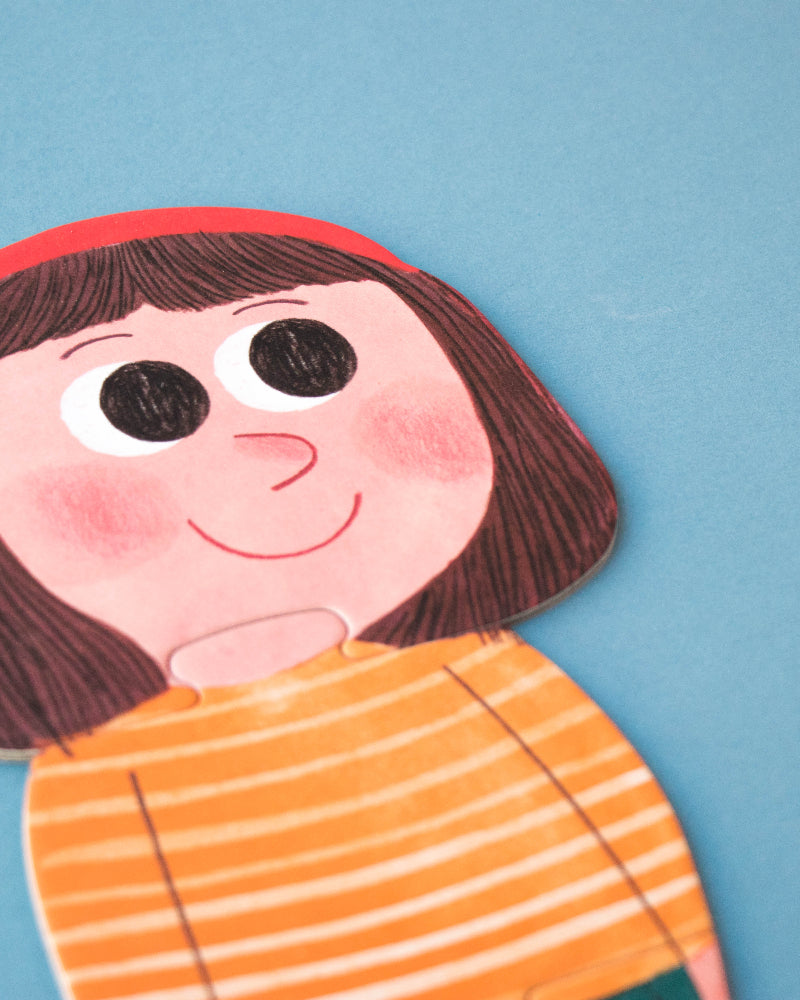 Colorful puzzle of a person with a red headband and orange striped shirt on a blue background