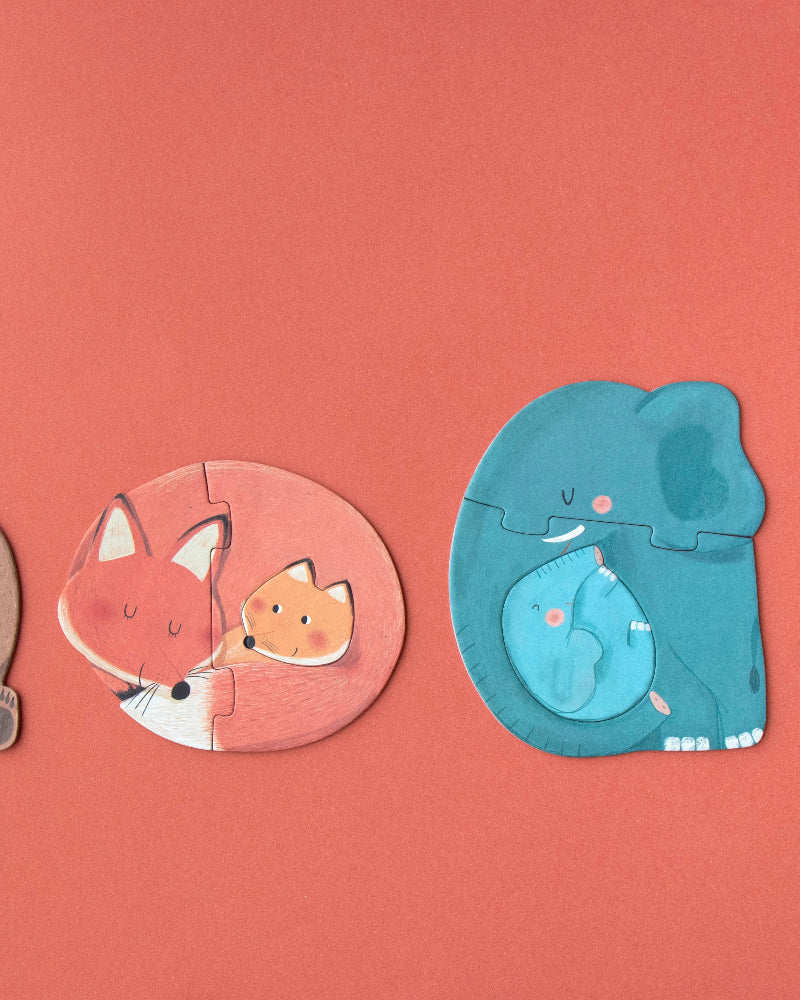 Four animal-shaped puzzles on a red background