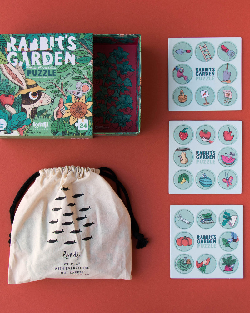 Educational children's products including a puzzle, drawstring bag, and sticker sheets on a red background