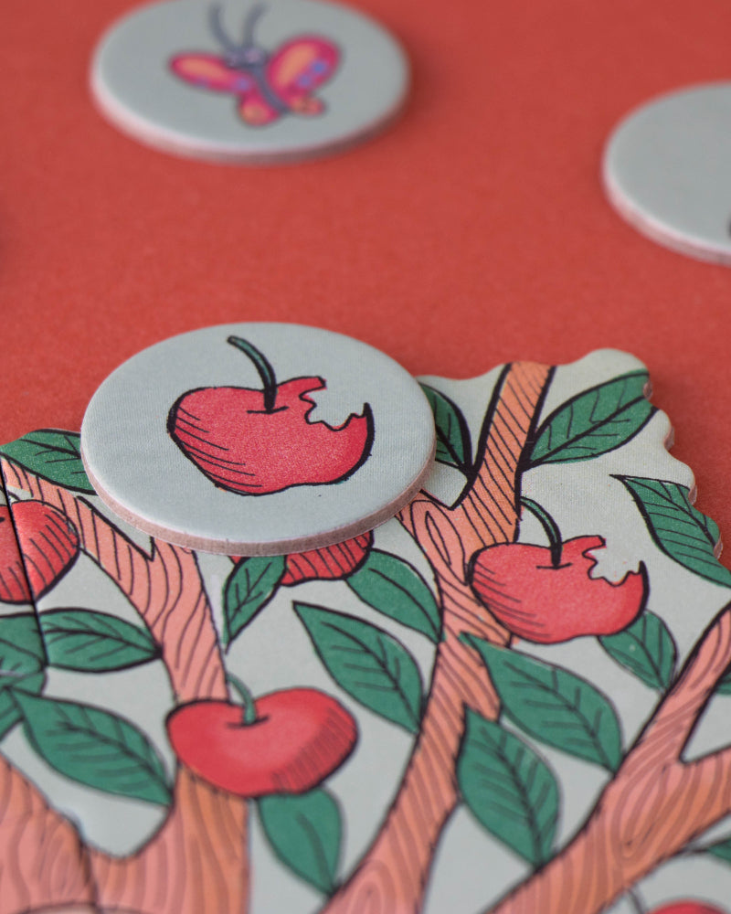 Decorative buttons with apple designs on a red background
