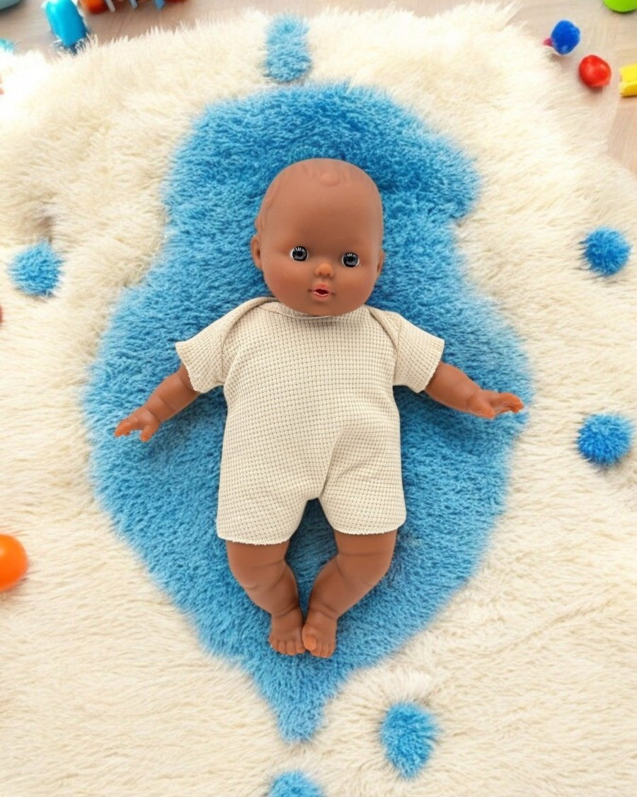 African American Baby Doll on a blue rug