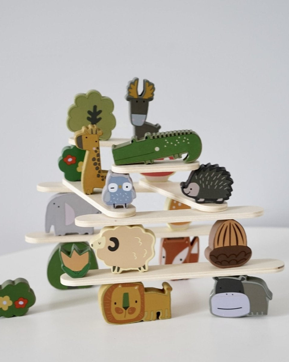 Wooden animal stacking blocks balanced on platforms demonstrating Montessori balancing activity