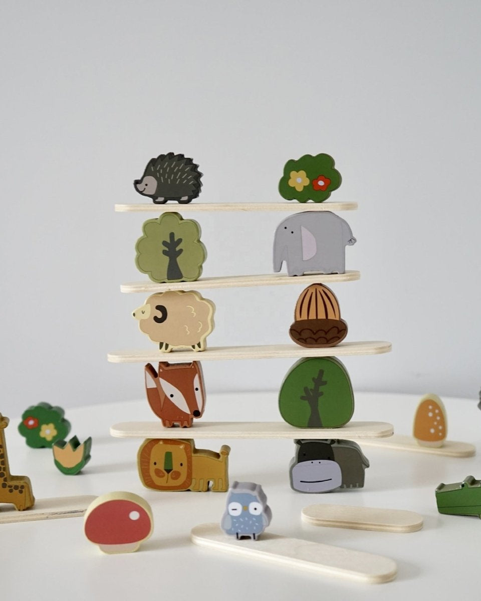 Forest-themed Montessori stacking blocks with various animals, mushrooms, and trees for creative play