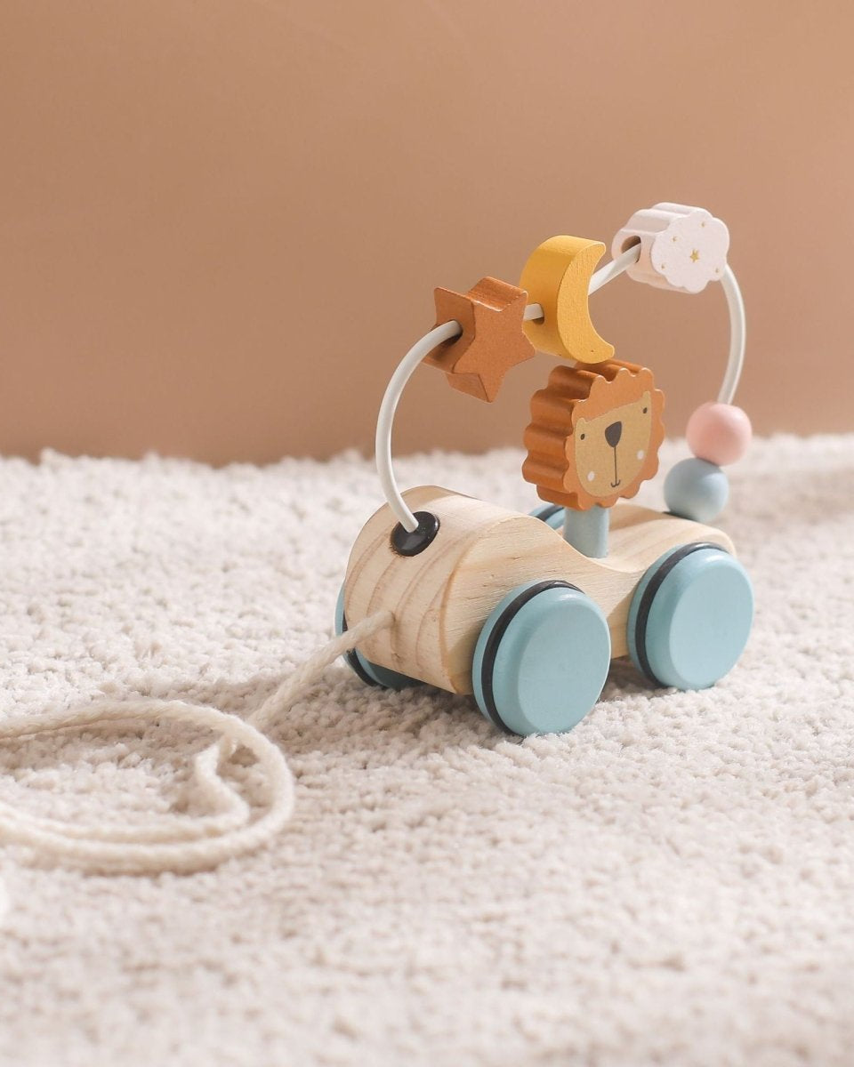 Natural wood pull toy featuring lion character with interactive bead path and celestial elements