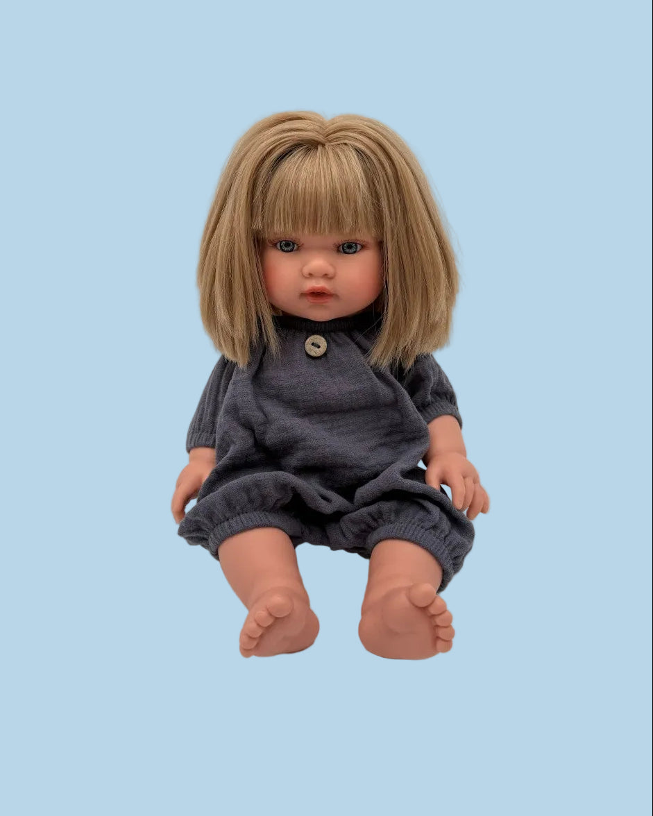 Handmade navy doll romper laid flat showing one-piece silhouette, elasticated cuffs, and button detail