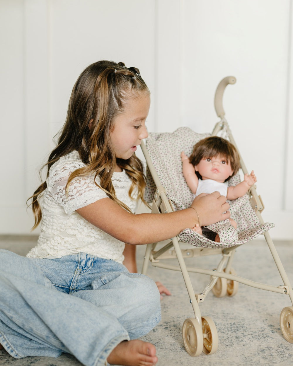 Older Girl Tucking Doll in Stroller