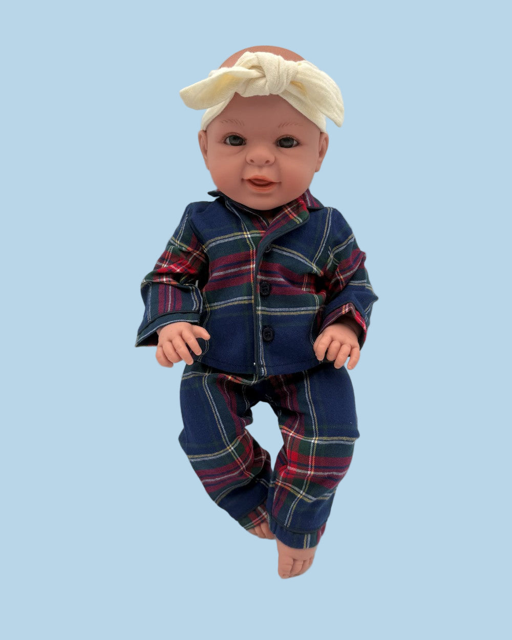 Coordinating doll and child pajama set in distinguished navy tartan with red and pink accents