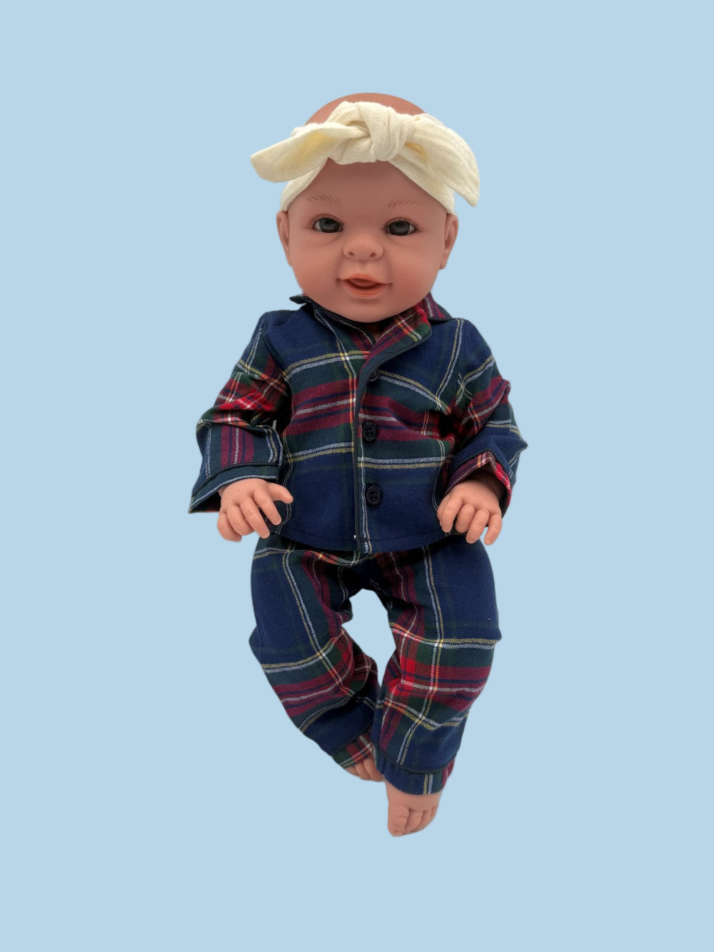 Coordinating doll and child pajama set in distinguished navy tartan with red and pink accents