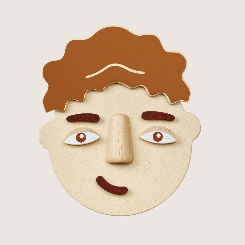 Close-up of PlanToys Build a Face two-sided components with different emotions