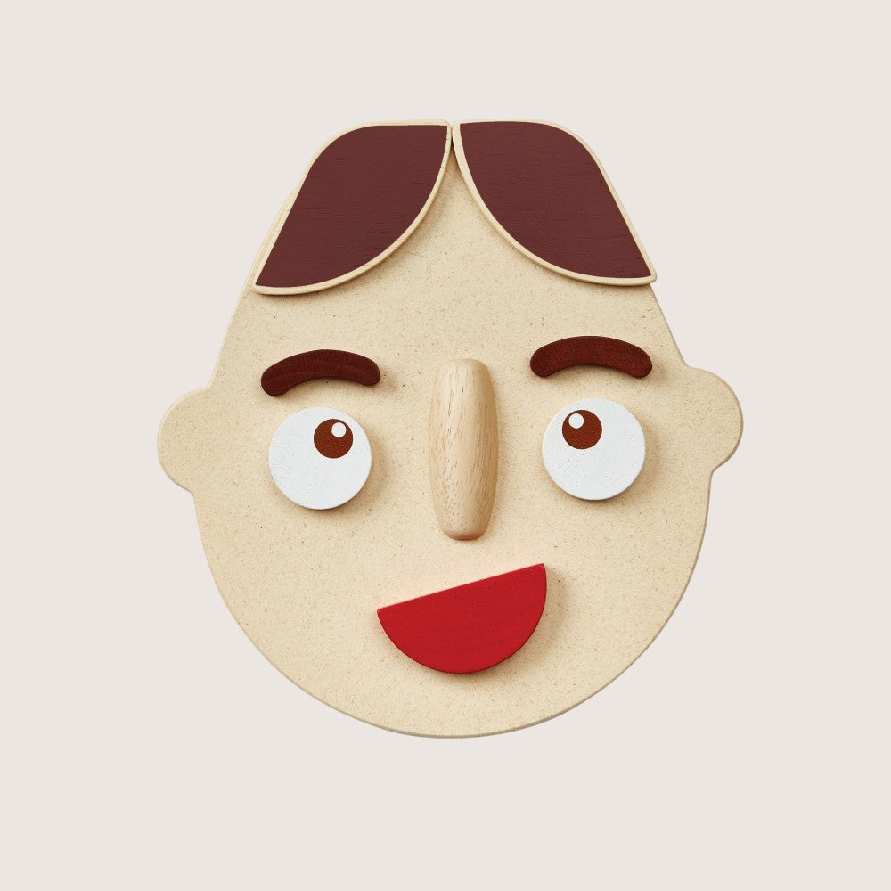 Close-up of PlanToys Build a Face two-sided components with different emotions